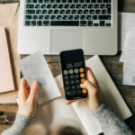 Small Business bookkeeping using a calculator on a phone screen.
