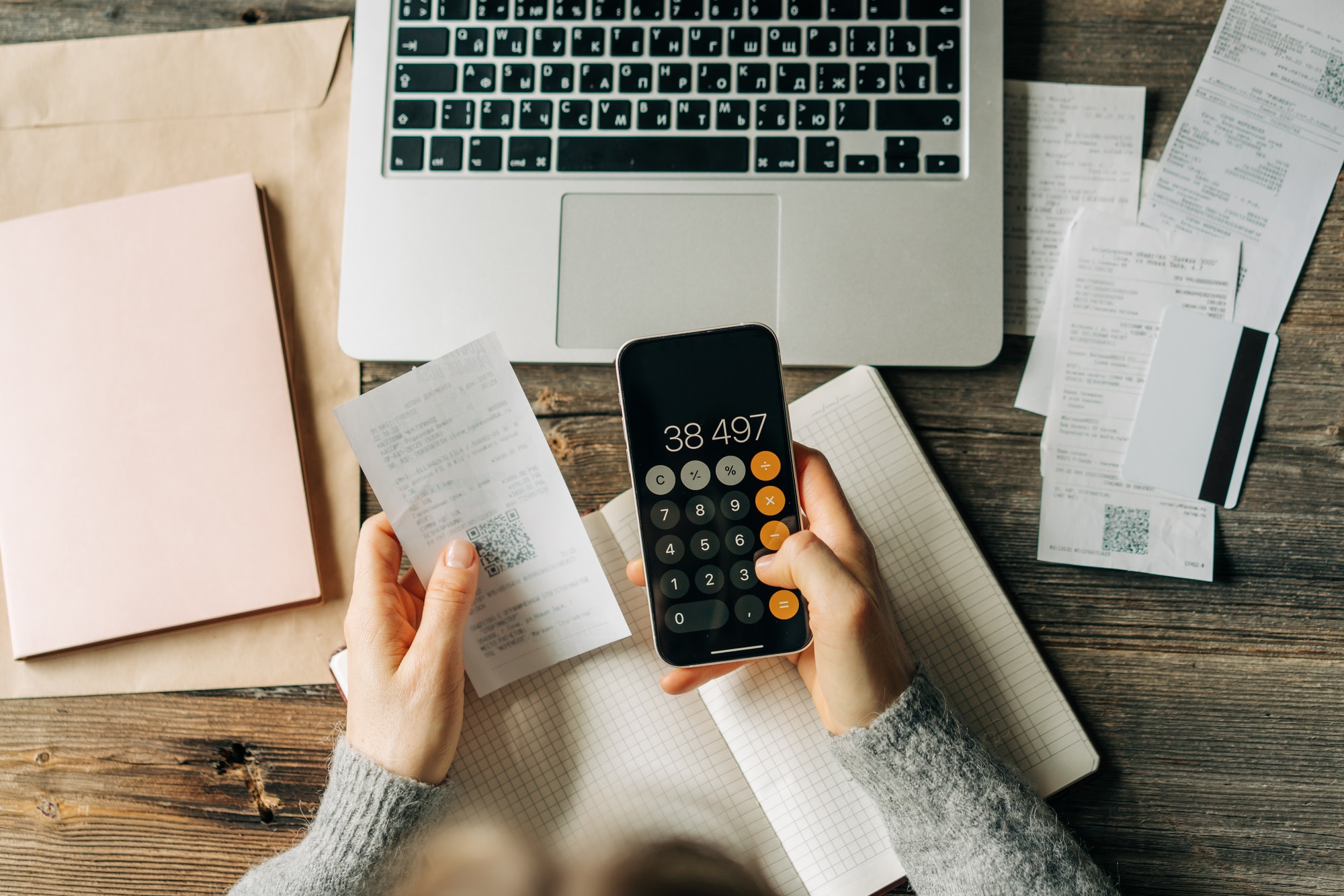 Small Business bookkeeping using a calculator on a phone screen.